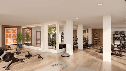 Gimnasio privado para residentes de Insur Elyonia. Sala totalmente equipada con máquinas de cardio y musculación, espejos de cuerpo entero y vistas a las zonas ajardinadas.